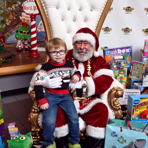 Santa distributing toys at St. Christopher's Hospital for Children