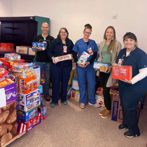 Employees help to fill weekender food bags for Reading-area children at the annual Reading Hospital Piece Per Person event.