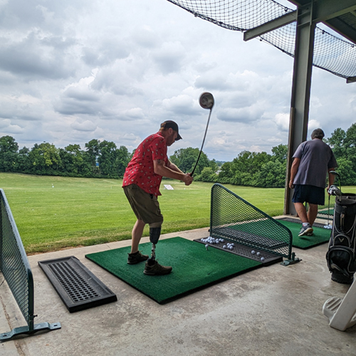 Golf Clinic participant practices his swing