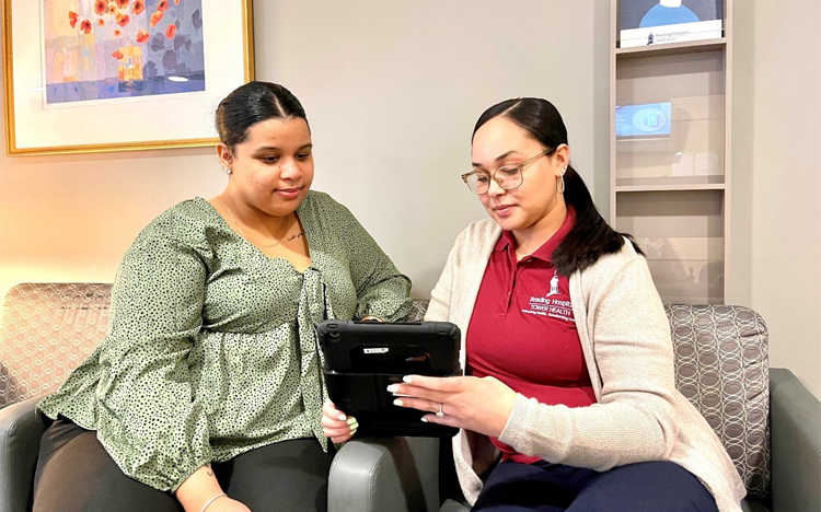 Two women sit and discuss connection programs in Berks County