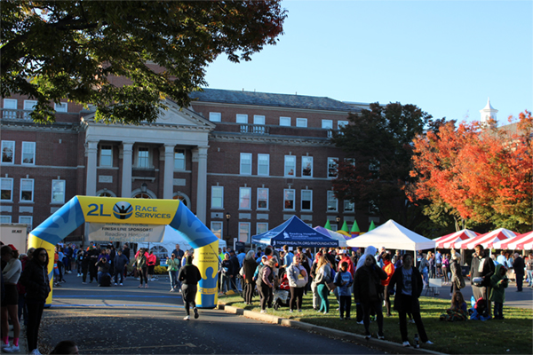 Crowds gather among autumn leaves at the Reading Hospital Road Run 2024