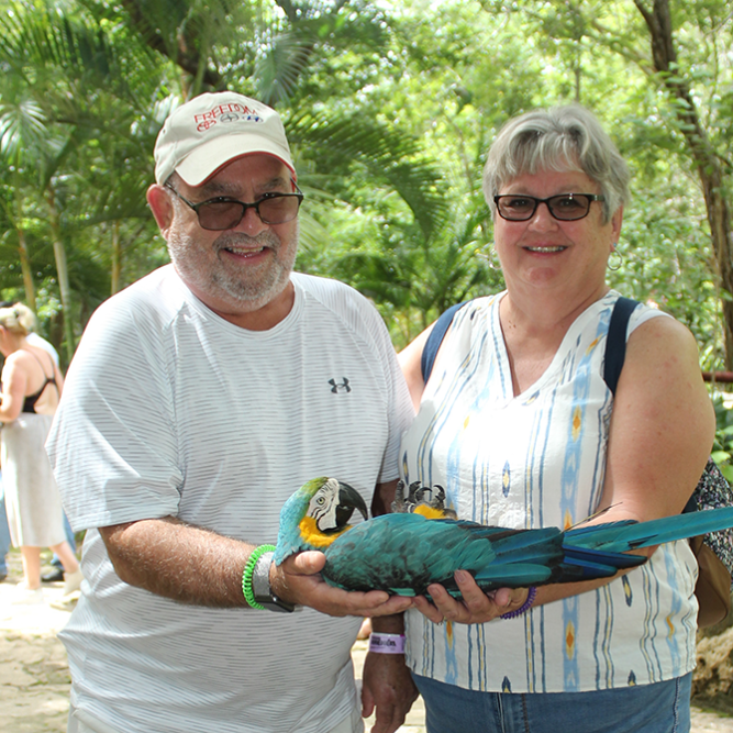 Robert Eisenhower with wife Brenda holding a parrot