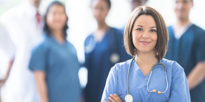 group of doctors with female doctor standing in front