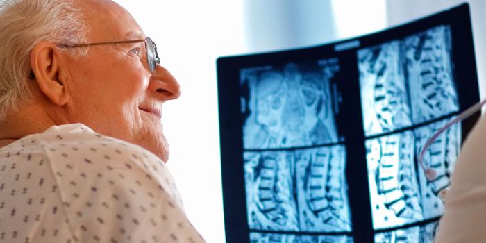 patient looking at spine x-ray