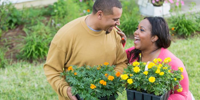 Couple holding flowers outside