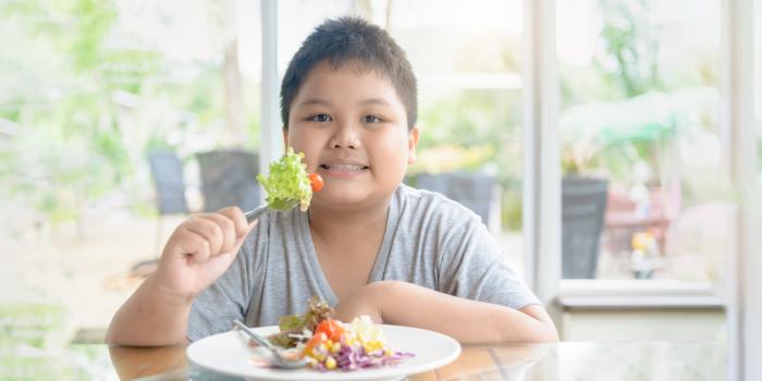 boy eating a salad