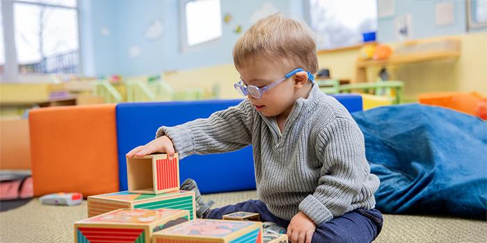 Toddler stacking blocks in occupational rehabilitation