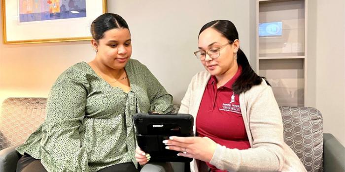 Two women sit and discuss connection programs in Berks County