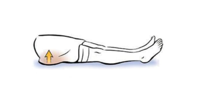 A person's leg is outstretched. Gluteus muscles are squeezed together to perform gluteus sets.